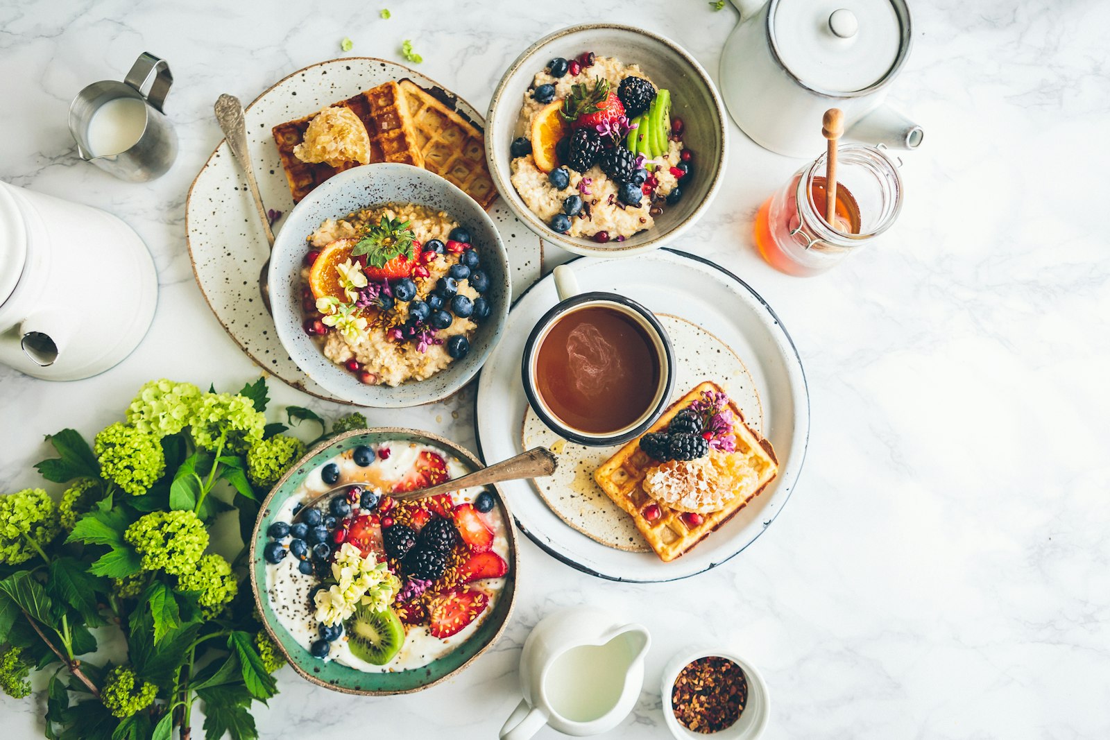 Bright breakfast table with fruit, yogurt, and tea for a calm morning routine